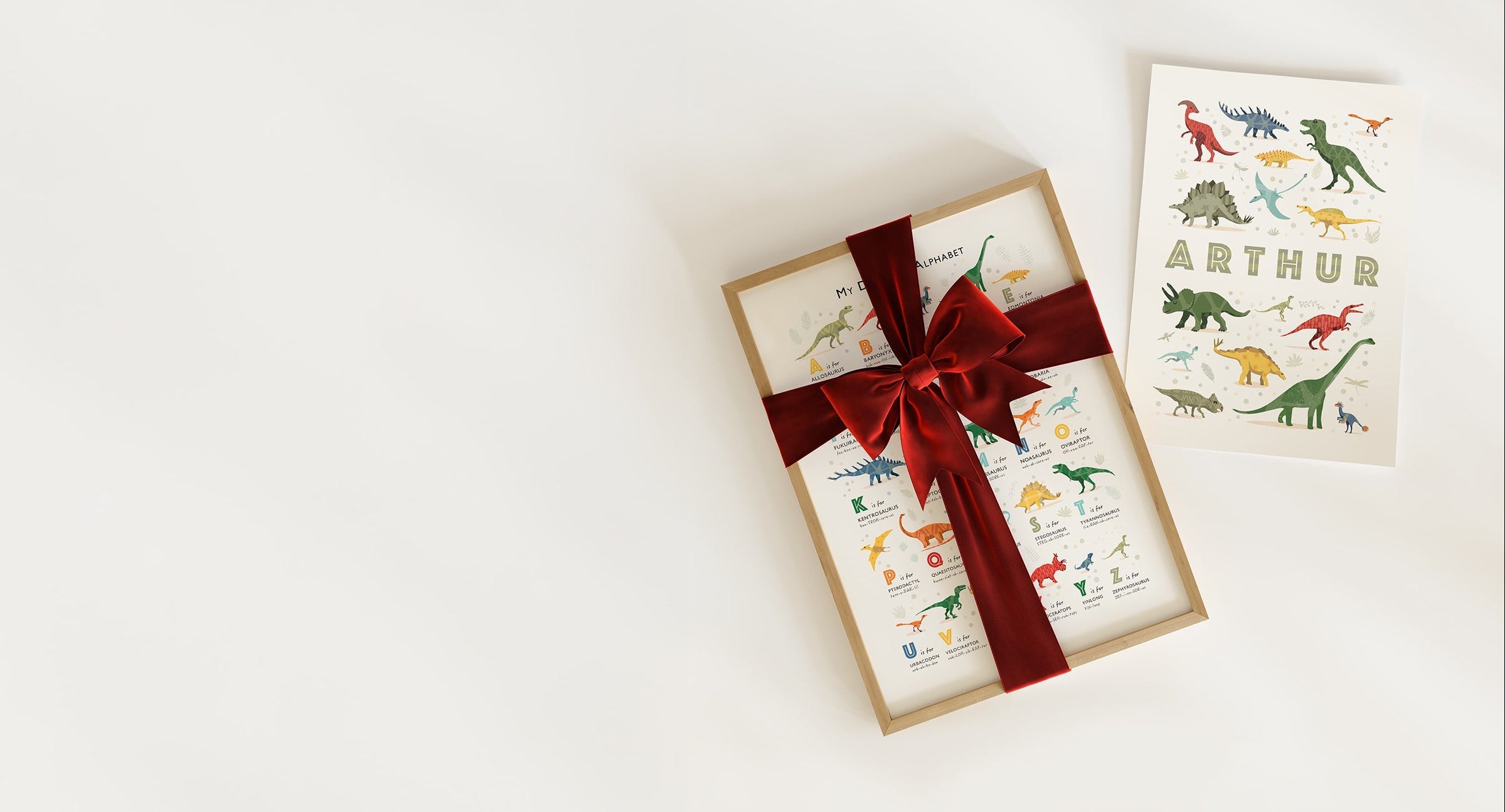 A collection of three matching nursery art prints, beautifully wrapped for Christmas, showcasing a complete gallery wall gift set.