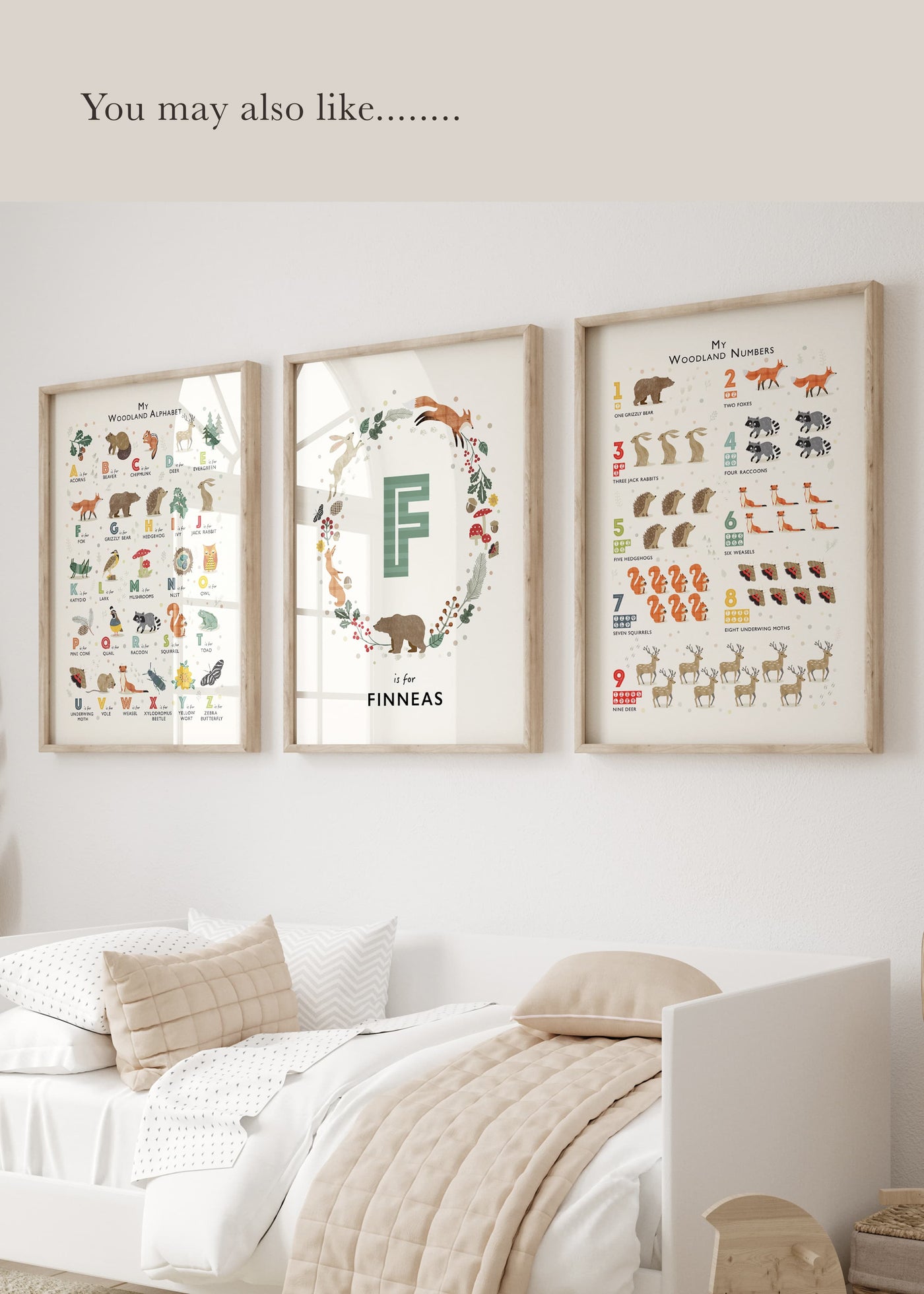  A set of 3 woodland themed prints, an alphabet,  a counting print and a personalised name print on a wall in a modern kids room