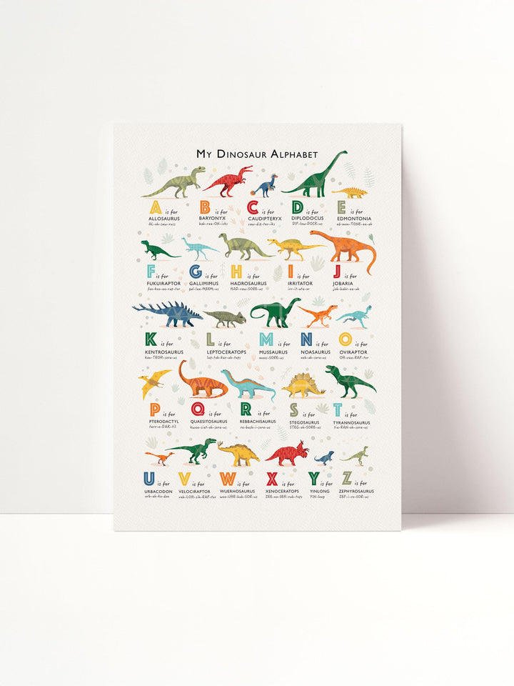Personalised dinosaur alphabet print flat lay — illustrated dinosaur A to Z poster for children’s bedroom or learning corner.