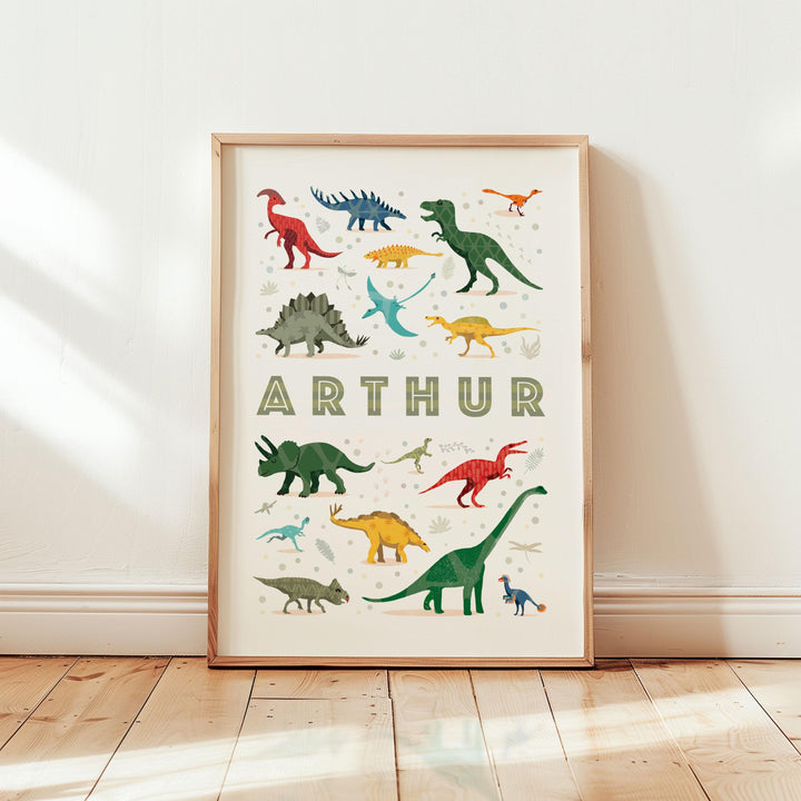Personalised Dinosaur Name Poster displayed in light-filled nursery with oak frame and soft neutral tones — educational wall art for kids.