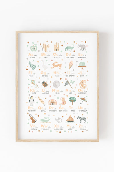 illustrated alphabet print in neutral colours in pine frame on white wall. 