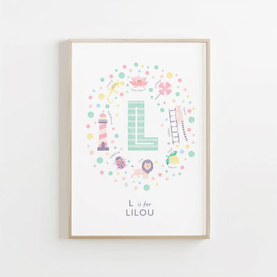Personalized letter L artwork with the name 'Lilou' in mint green, framed on a cream wall. Perfect for a baby's nursery.