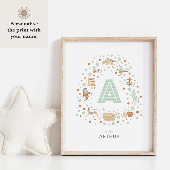 Newborn gift idea Initial Letter Print in green in wooden frame against white wall with cloth star to left