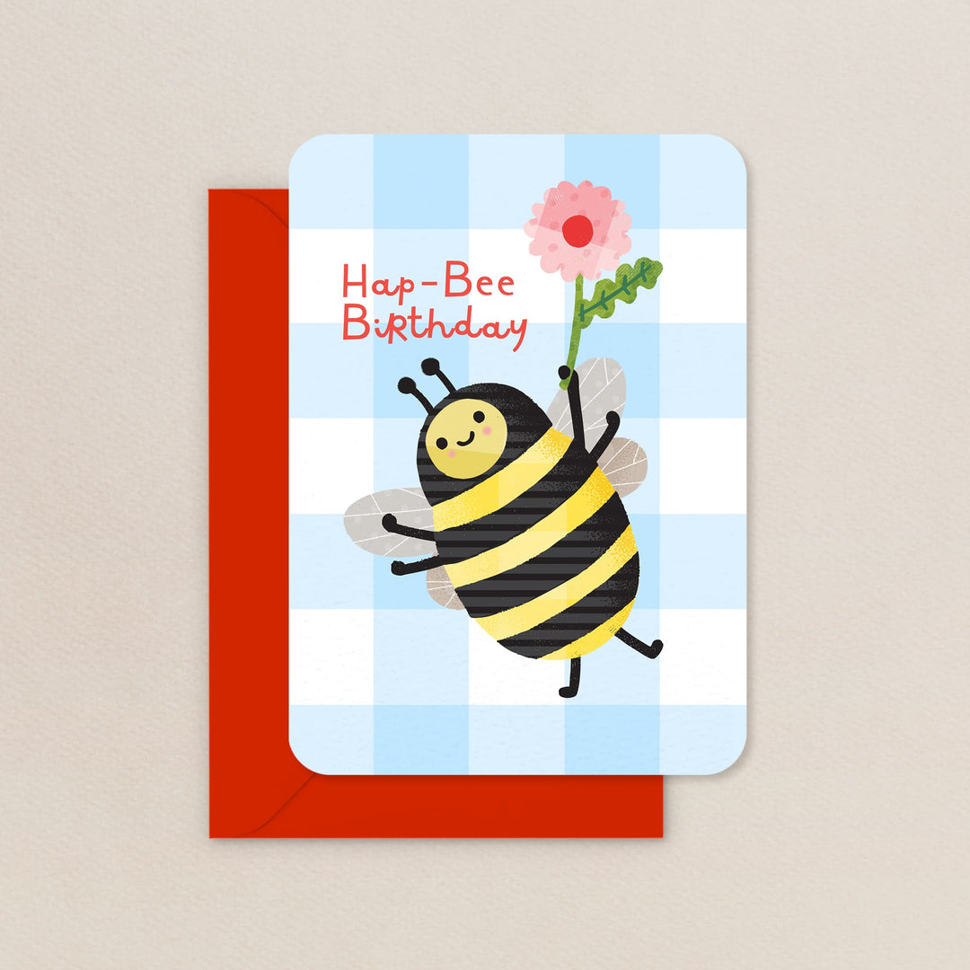 Birthday card with a bee holding a flower on a checkered background