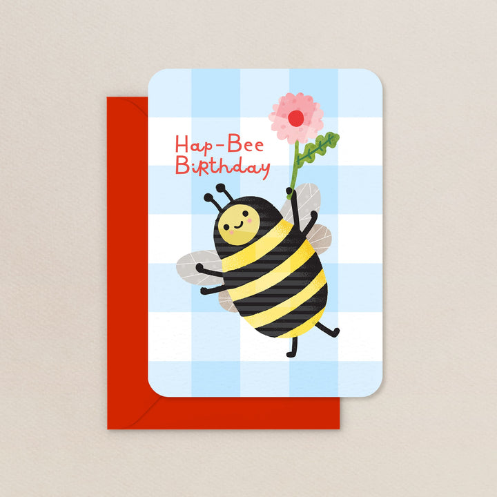 Birthday card with a bee holding a flower on a checkered background