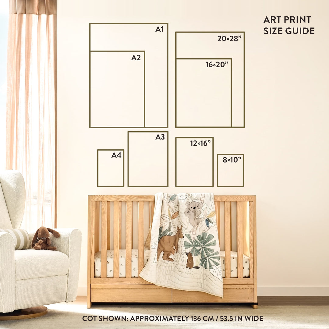 A nursery room scene showing a wooden crib with a deer-patterned blanket, a white armchair with a stuffed dog, and wall-mounted art print size guide diagrams above it. Text reads &