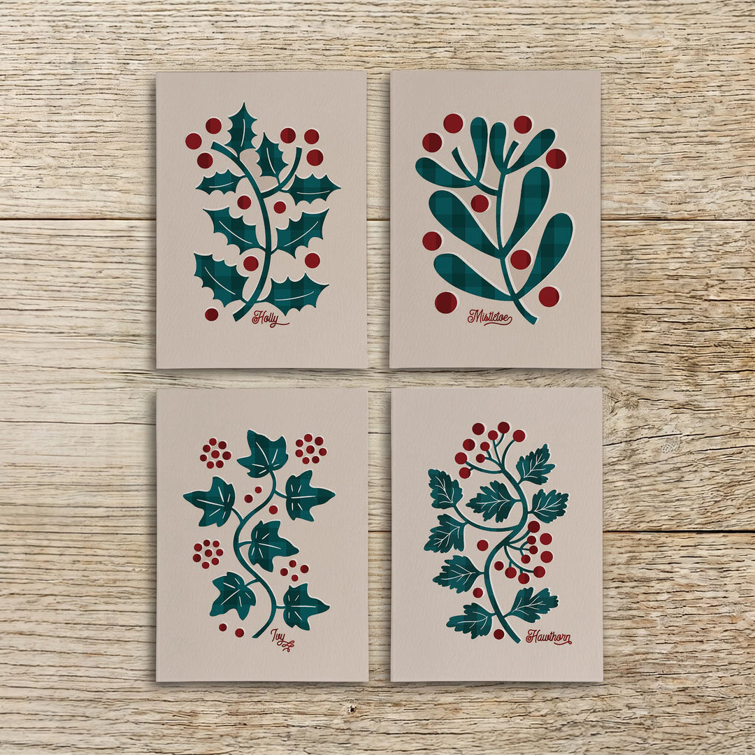 Four botanical Christmas cards featuring holly, mistletoe, ivy and hawthorn arranged together