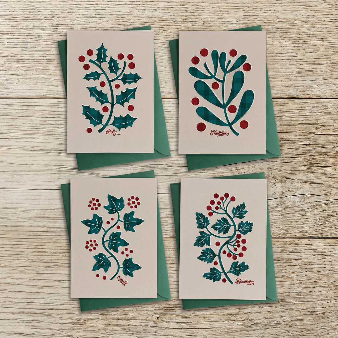 Set of four botanical Christmas cards with holly, mistletoe, ivy and hawthorn designs and green envelopes