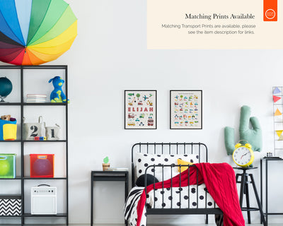 Stylish children&#39;s room with a black iron bed and colourful decor, featuring two framed personalized transport name prints &#39;ELIJAH&#39; and matching designs on the shelf.
