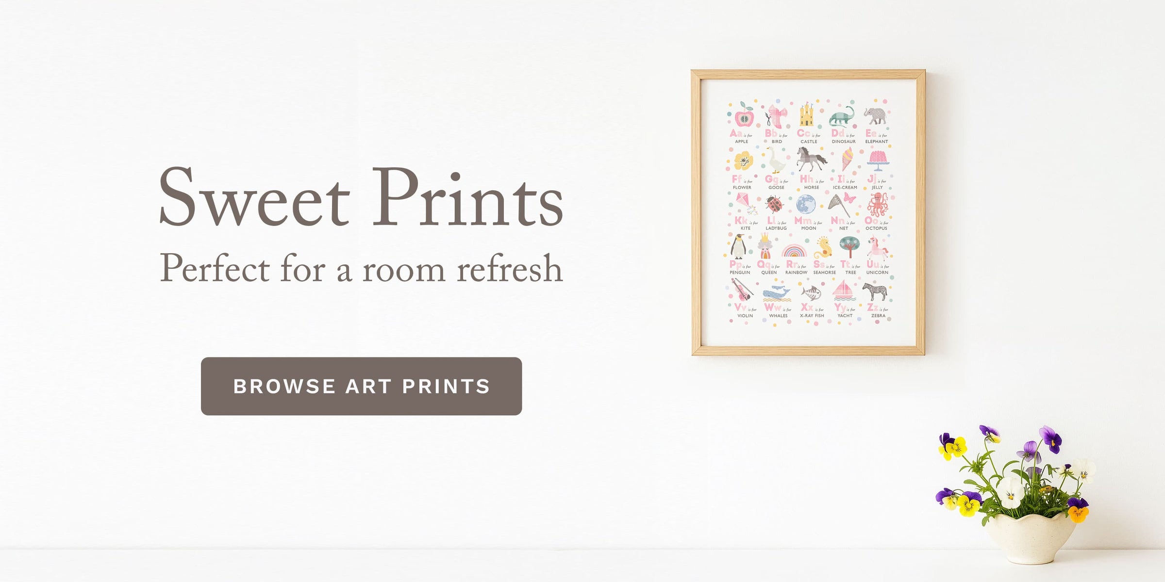 Framed pink alphabet art print on a wall with 'Sweet Prints' branding and a call to action button.