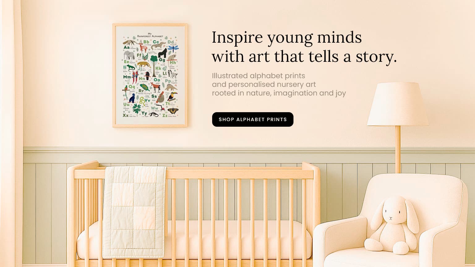 bright and sunny nursery with crib and illustrated alphabet print on the wall and the text- inspire young minds with art that tells a story.