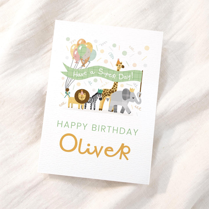 A personalised birthday card with the name 'Leo' surrounded by safari animals like a lion, elephant, and giraffe.