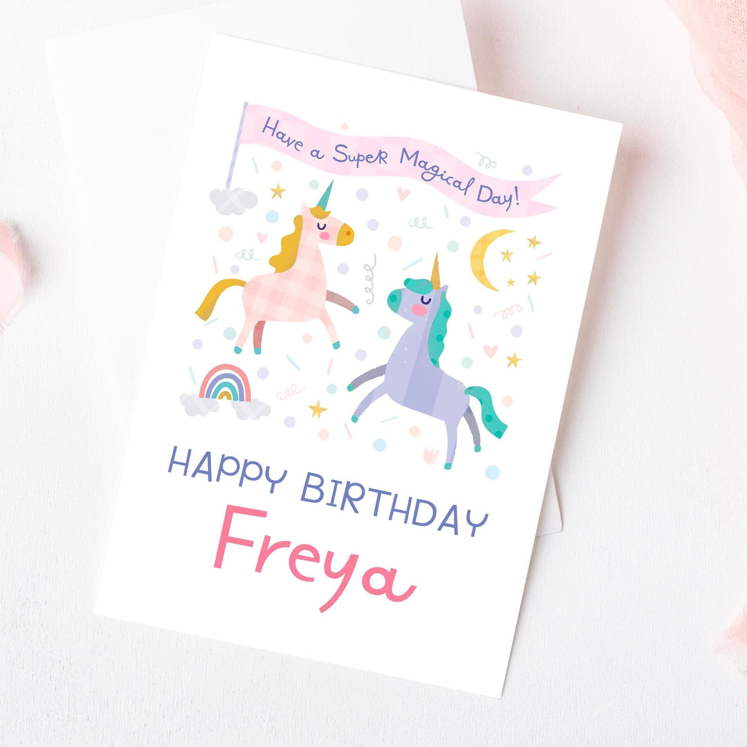 A personalised unicorn birthday card for a girl, featuring an illustrated unicorn in a magical setting and the name 'Freya'