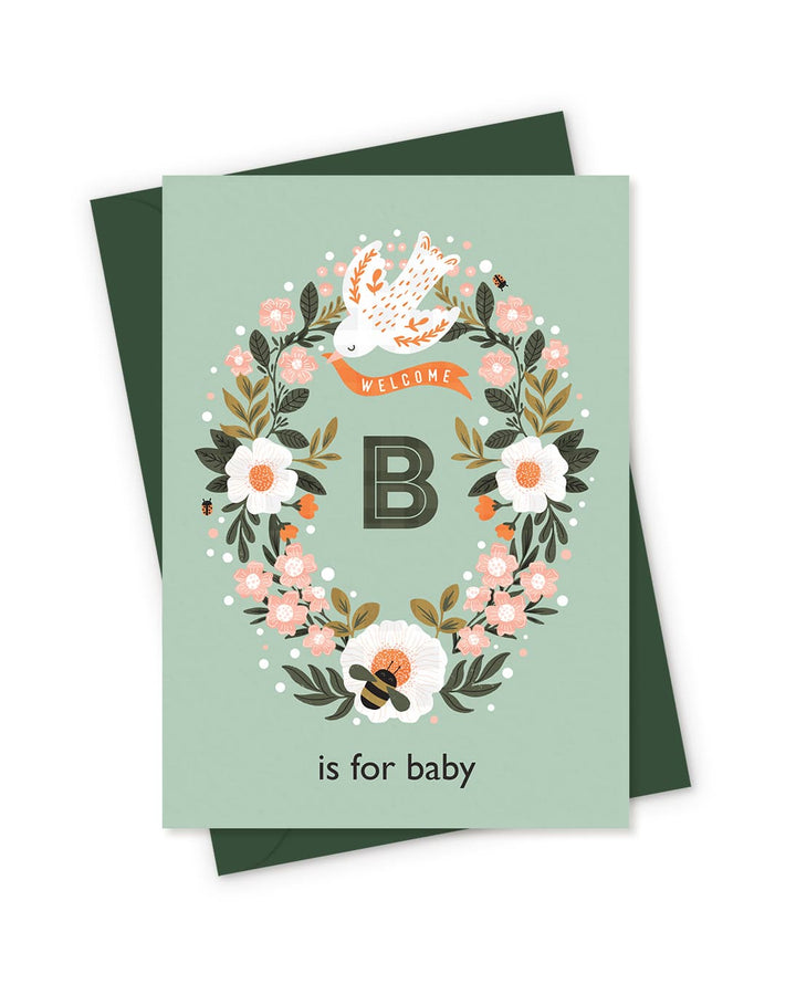 he 'B is for Baby' new baby card, shown in a soft green colourway and featuring a letter B inside a floral wreath.