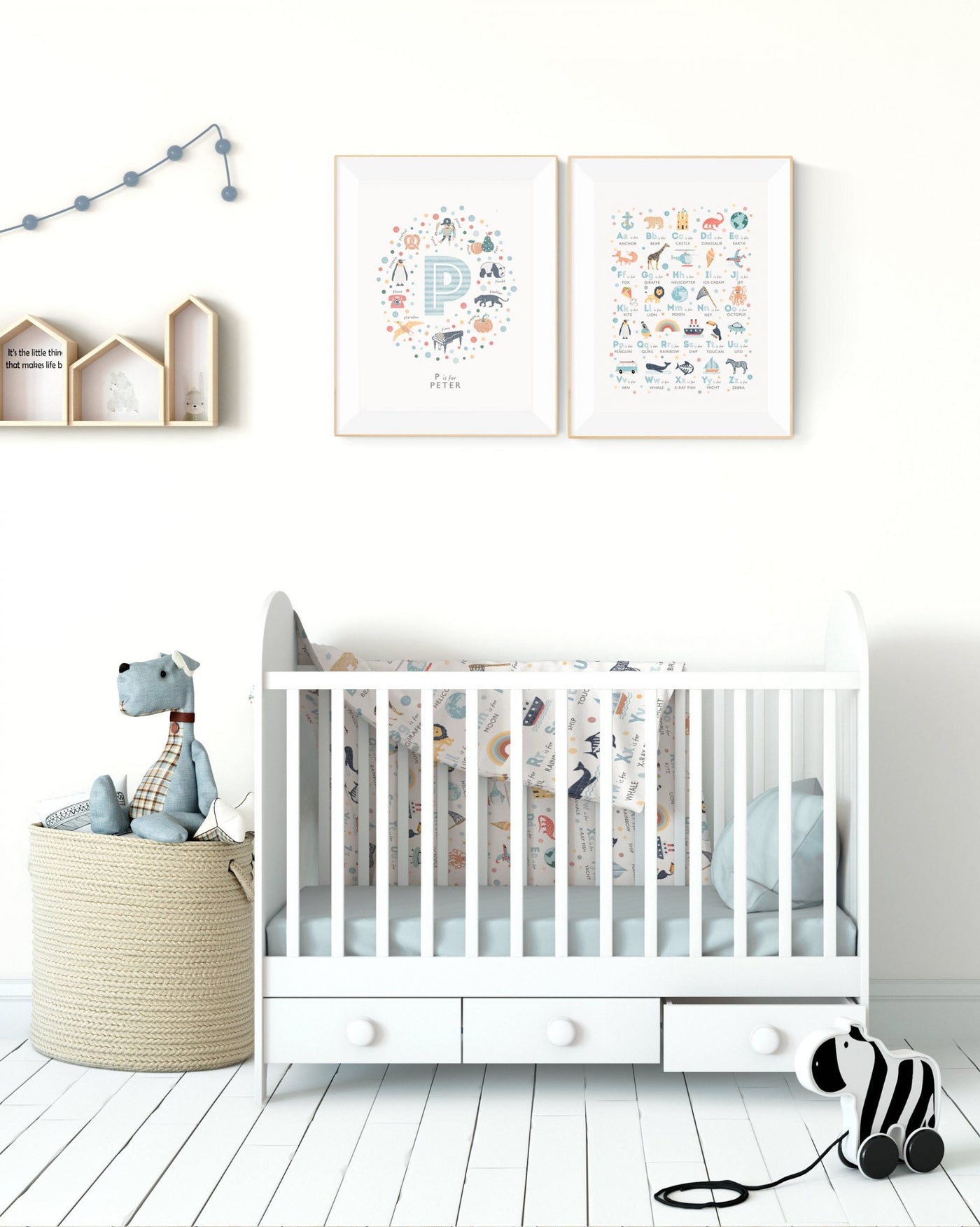 Interior nursery scene with the Boys Alphabet Nursery Print and a personalised initial letter print framed and hung on a wall over a crib, soft toys and shelves are also in the picture