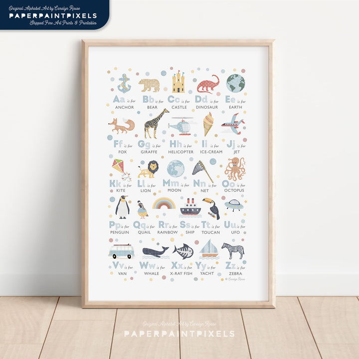 A printable alphabet poster in shades of blue, shown framed and styled in a calm, modern boy's nursery.