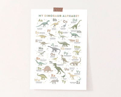 Dinosaur Alphabet Poster in Earth Tone Colours unframed on a cream wall