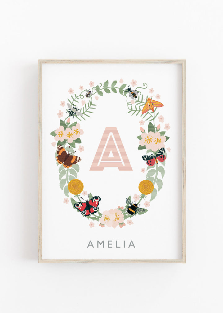 A personalised name print for a girl named 'Amelia', featuring her name inside a delicate wreath of butterflies, moths, and wildflowers